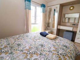 A bedroom with bed and dressing table at 15 Cherry Tree walk Rhyl