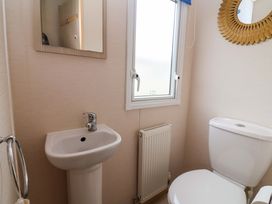 A bathroom with sink and toilet at 15 Cherry Tree walk in Rhyl