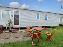 A mobile home with a table and chairs at 15 Cherry Tree walk Rhyl
