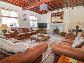 A living room with a sofa and television at Tuft House in Hovingham
