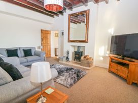 A living room with a television and fireplace at Tuft House Hovingham