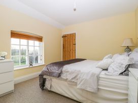 A bedroom with a bed and dresser at Tuft House Hovingham