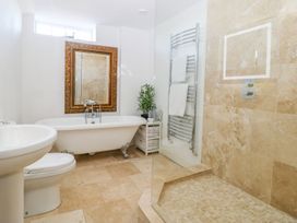 A bathroom featuring a bathtub, shower, and sink at Tuft House in Hovingham
