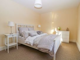 A bedroom with a bed and bedside table at Tuft House in Hovingham