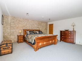A bedroom with a bed and furniture at Tuft House in Hovingham
