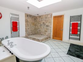 A bathroom with a bathtub and shower at Tuft House in Hovingham