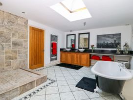A bathroom with a bathtub and sinks at Tuft House in Hovingham
