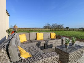 An outdoor seating area with a sofa and coffee table at Tuft House in Hovingham