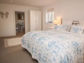 A bedroom with a bed and wardrobe at Tuft House in Hovingham