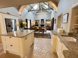 A kitchen with a dining area and living space at The Chimney in Bamburgh