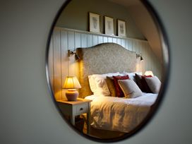 A bedroom with a bed and bedside lamp at The Chimney in Bamburgh