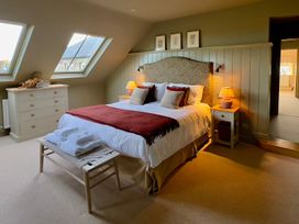 A bedroom with a bed and chest of drawers at The Chimney in Bamburgh