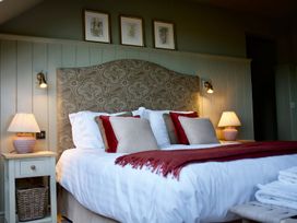 A bedroom with a bed and nightstand at The Chimney in Bamburgh