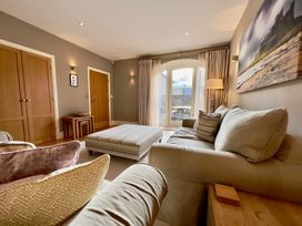 A living room with a sofa and coffee table at The Chimney in Bamburgh
