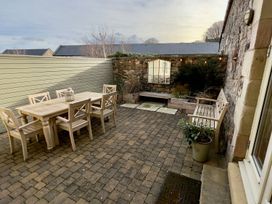 A garden with a table and chairs at The Chimney in Bamburgh