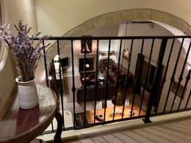 A living room viewed from above with a lavender plant and a railing at The Chimney in Bamburgh