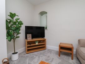 A living room with a TV and plant at Helmsley Cottage in Helmsley