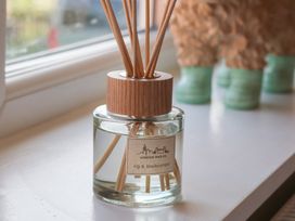 A reed diffuser on a windowsill at Helmsley Cottage in Helmsley