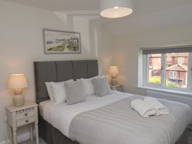 A bedroom with a bed and bedside tables at Helmsley Cottage in Helmsley