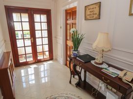 A hallway with double doors and a table with a lamp at Marie's Country Home in Ardee, County Louth