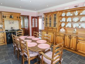 A kitchen with a wooden table and chairs at Marie's Country Home, Ardee, County Louth