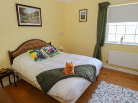A bedroom with a bed and stuffed toy at Marie's Country Home in Ardee, County Louth