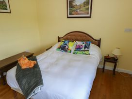 A bedroom with a bed and decorative pillows at Marie's Country Home, Ardee, County Louth