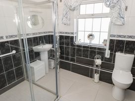 A bathroom with a shower, sink, and toilet at Marie's Country Home, Ardee, County Louth