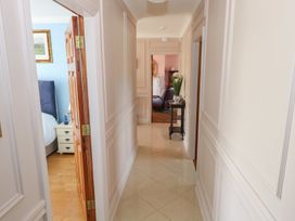 A hallway with doors to rooms and furniture at Marie's Country Home Ardee, County Louth
