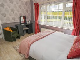 A bedroom with a bed and a mirror at Marie's Country Home, Ardee, County Louth