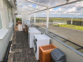 A utility room with washers and a sink at Marie's Country Home Ardee, County Louth