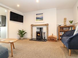A living room with a fireplace and television at Ty Bryn in Marazion