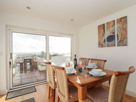 A dining room with a table set for meals at Ty Bryn in Marazion