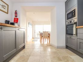 A kitchen with a dining area and appliances at Ty Bryn in Marazion