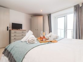 A bedroom with a bed and television at Ty Bryn in Marazion