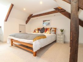 A bedroom with a bed and nightstand at Ty Bryn in Marazion