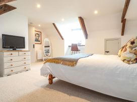 A bedroom with a bed and television at Ty Bryn in Marazion