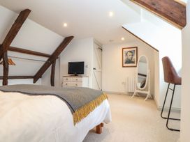 A bedroom with a bed and a TV at Ty Bryn in Marazion