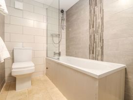 A bathroom with a bathtub and toilet at Ty Bryn in Marazion
