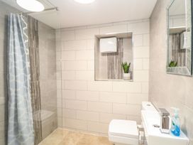 A bathroom with a shower, toilet, and sink at Ty Bryn in Marazion