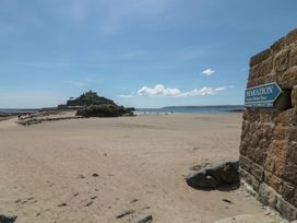 A beach view with a castle in the background at Ty Bryn in Marazion
