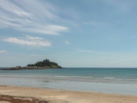 A beach with an island in the background at Ty Bryn in Marazion