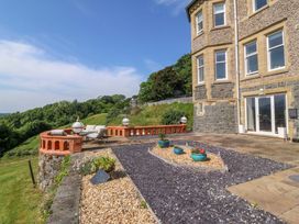 An outdoor area with seating and flower pots at Apartment 1, Bryn Mel Manor Menai Bridge