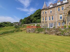 An outdoor area with a lawn and building at Apartment 1, Bryn Mel Manor Menai Bridge