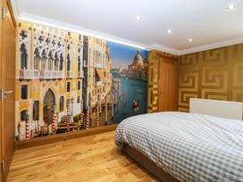 A bedroom with a bed and a mural of Venice at Apartment 1, Bryn Mel Manor in Menai Bridge