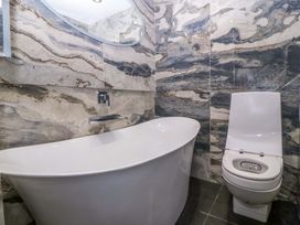 A bathroom with a bathtub and toilet at Apartment 1, Bryn Mel Manor Menai Bridge