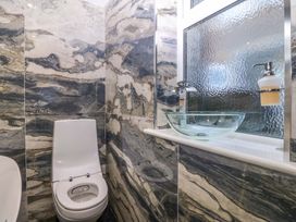 A bathroom with a toilet and a glass wash basin at Apartment 1, Bryn Mel Manor Menai Bridge