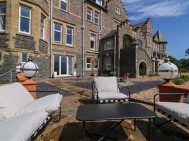 An outdoor seating area with a table and decorative lights at Apartment 1, Bryn Mel Manor Menai Bridge