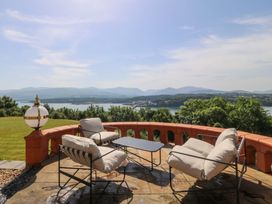 A garden with outdoor seating and a table at Apartment 1, Bryn Mel Manor in Menai Bridge