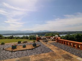 An outdoor patio with views of mountains and water at Apartment 1, Bryn Mel Manor Menai Bridge